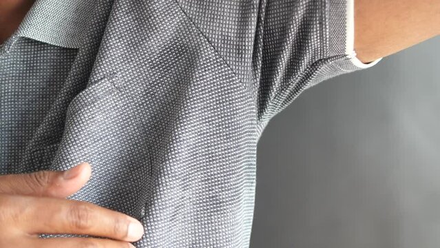man with wet armpits Smelly odor from sweat .