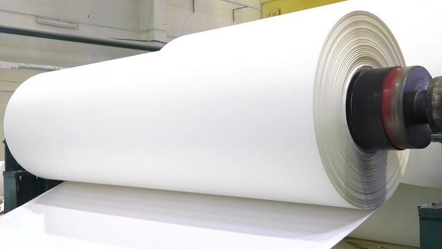 The machinery in a paper mill plant. Paper production machine in waste paper recycling factory. Paper and pulp mill.
