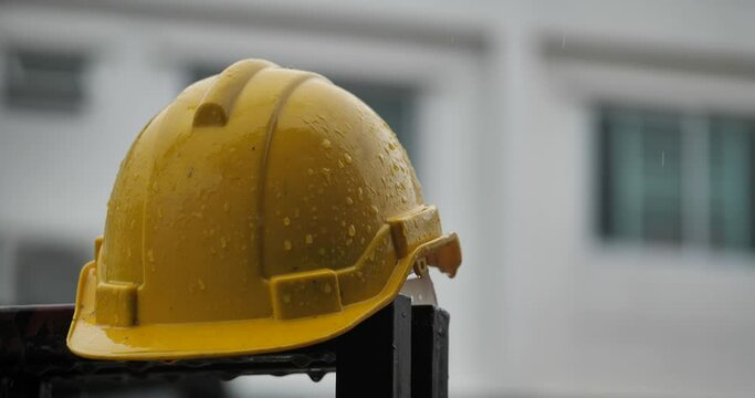 Raindrops on a construction helmet,heavy rain and construction safety helmets, blue hard safety helmet and raining