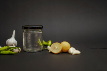 Red Chilli, lemon, garlic on black background