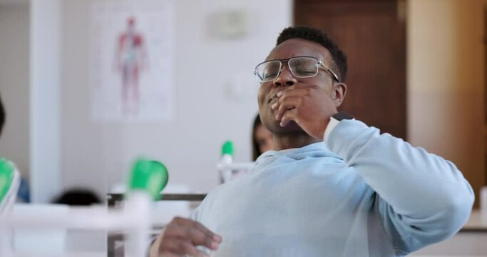 Tired student, yawn and black man in university at classroom, stress or lazy. Fatigue, bored and insomnia of African person, exhausted and education challenge in learning, studying or college burnout