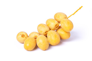 Fresh yellow date fruit isolated on white background.