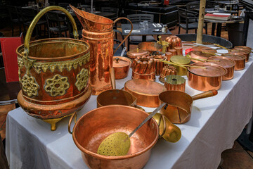 Vintage copper cookware pots and pans for sale at the Cours Saleya outdoor flea market in Old Town...