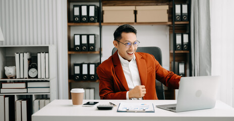 business man are delighted and happy with the work they do on their tablet, laptop and taking notes at the office.