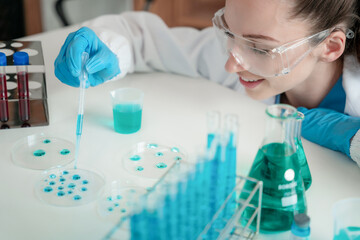 Scientist mixing chemical liquids in the chemistry lab. Researcher working in the chemical laboratory.