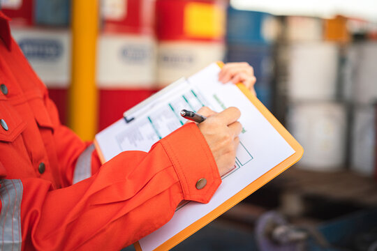 A safety engineer is using pen to rating the health risk assessment level of chemical hazardous material in the paperwork form. Industrial safety working scene, close-up and selecitve focus.	
