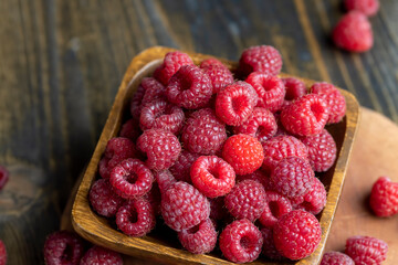Ripe raspberries on a wooden board