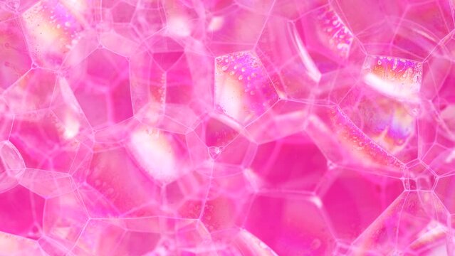 Magic wallpaper, soap sud macro structure. Pink foam soap with bubbles, rotates abstract background. Colorful soap foam with popping bubbles background. Abstract macro molecule pattern.