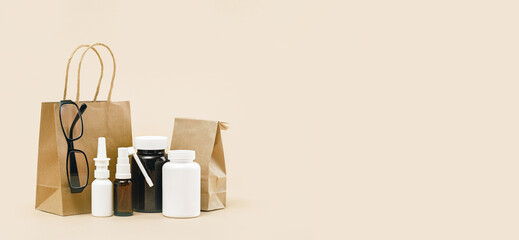 pharmacy order delivery. prescription drugs and over the counter medication. Pills and spray mockup vial containers and buff paper bags. Glasses optitian. Drugstore shopping copy space