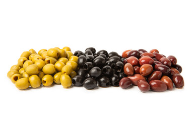 Green, black and red olives isolated on white background. Various types of olives and with fresh olive leaves. Mediterranean food. Vegan.