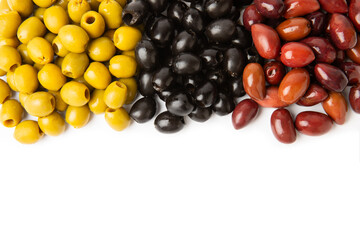 Green, black and red olives isolated on white background. Various types of olives and with fresh olive leaves. Mediterranean food. Vegan.