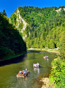 Summer landscape of Pieniny mountains. Traditional rafting on the Dunajec River on wooden boats. The rafting is very popular tourist attraction in Pieniny National Park