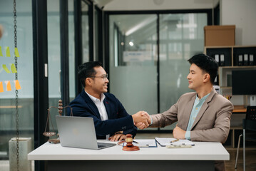 Fototapeta na wymiar Business and Male lawyer or judge consult having team meeting with client, Law and Legal services concept.Customer service good cooperation in office