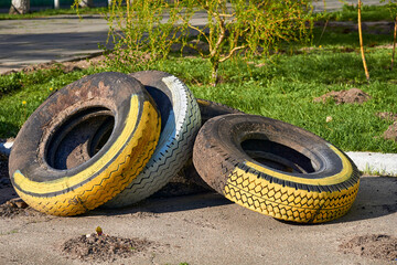 Old car tires used to create flower beds, street decor, fence