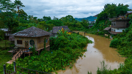 Fototapeta na wymiar Village and mountain in Vang Vieng, Laos, Nam Song River in Vang Vieng, Laos.