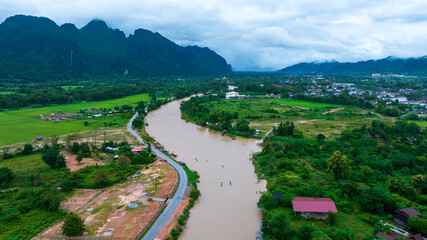 Village and mountain in Vang Vieng, Laos, Nam Song River in Vang Vieng, Laos.