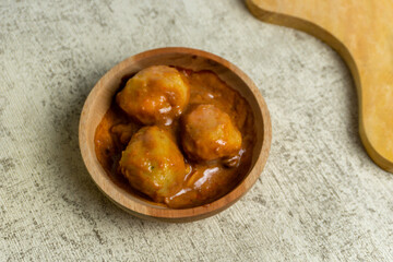 Boiled tapioca balls served with peanut sauce. Indonesian street food called cilok or pentol