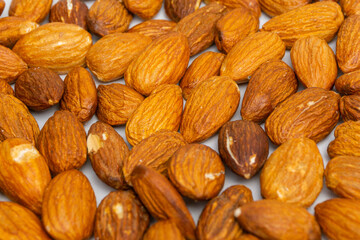 Almonds on white background. Raw peeled almond nuts texture