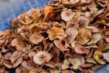 Dried apples. Sliced dried apples on a blue background. Homemade dried organic apple.