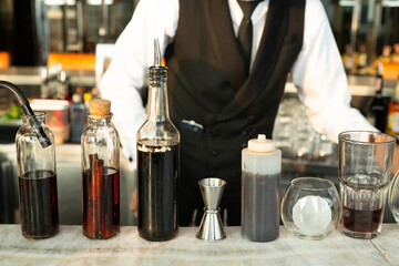 Cocktail ingredients on bar prepared by bartender