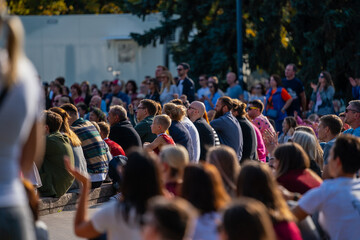 Crowd sitting and watching a game on public event