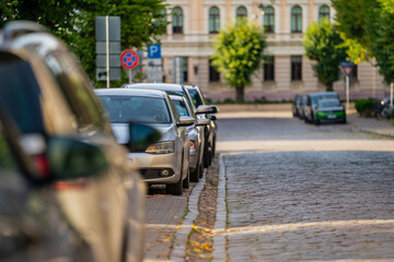 Cars parked next to paved street