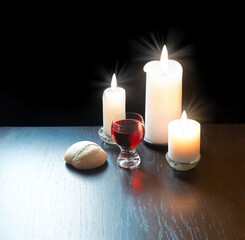 A bowl of wine and bread on the table. Communion symbols