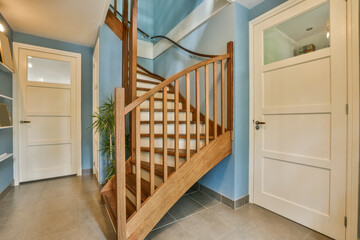 a staircase way in a house with blue walls and white trim on the stairs, there is an open door