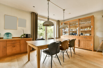 a dining room with wooden furniture and an open door that leads to the outside patio, which has been used for several years