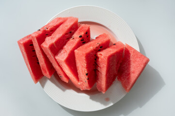 Sliced watermelon on white plate