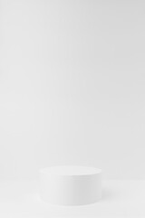 Abstract one white round pedestal for cosmetic products as mockup on white background. Scene for presentation products, gifts, goods, advertising, design, sale, text, showing in simplicity style.