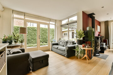 a living room with couches, chairs and a fire place in the middle part of the room on the right side