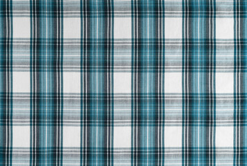 Turquoise checkered texture fabric, tartan pattern. Shirt fabric, tablecloth textile, linen plaid cloth, classic scottish check pattern. Backdrop, wallpaper, background.