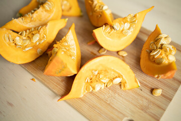 pieces of pumpkin on a wooden surface. Diet, proper nutrition, pumpkin benefits, vitamins all year round, rich harvest