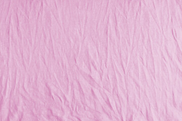 Wrinkled, crumpled pink fabric texture background. Wrinkled and creased abstract backdrop of cotton...