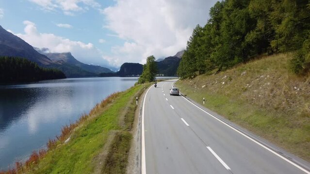 Sils Maria, Switzerland: Aerial drone footage on the road along lake Sils in the Engadin valley near St Moritz in Canton Graubunden in the Swiss alps in late summer. 