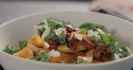 Pasta salad with sun dried tomatoes, kale and almond flakes
