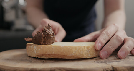 Man spreading chocolate paste on white bread