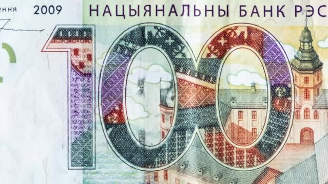 Hundred BYN cash money banknotes macro view. 100 belarusian ruble bills Stop Motion. Background from bills money. Closeup. National bank of the republic of belarus NBRB. Concept currency exchange. BY.