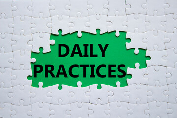 Daily Practices symbol. White puzzle with words Daily Practices. Beautiful green background. Psychology and Daily Practices concept. Copy space.