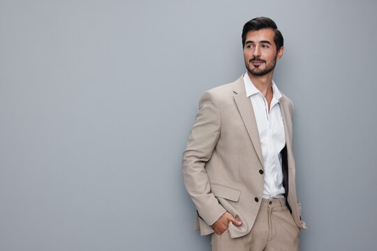 happy man business businessman handsome smiling sexy suit copyspace portrait beige