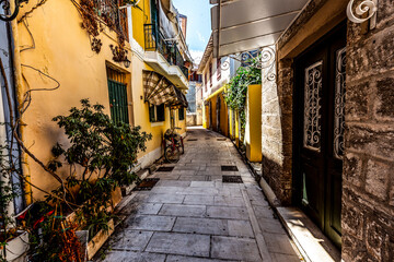 Fototapeta na wymiar Colourful Lefkada street with yellow buildings, Lefkada, Greece