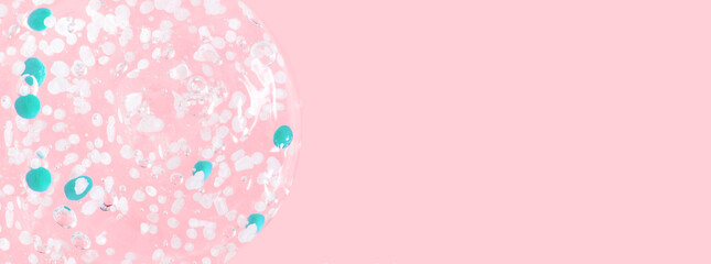 smears and drops of transparent gel with blue granules. On a pink background. - obrazy, fototapety, plakaty