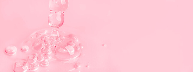 Dropping gel from an eyedropper on a pink background. Cosmetics Lab. Serum, gel, retinol, oil.