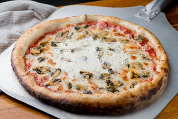 Pizza with mussels and otherseafood with melted cheese.