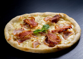 Pizza with bacon, ham, jamon and Parmesan.