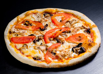 Pizza with mushrooms and chicken with tomato sauce and melted cheese. View from above