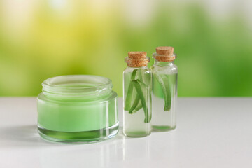 Aloe vera. Aloe vera cosmetic product, natural ingredients and laboratory glassware. Against the backdrop of nature with a sun glare.Cream, gel, mousse, mask.