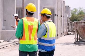 Engineer working at construction site, prefabricated cement wall factory.