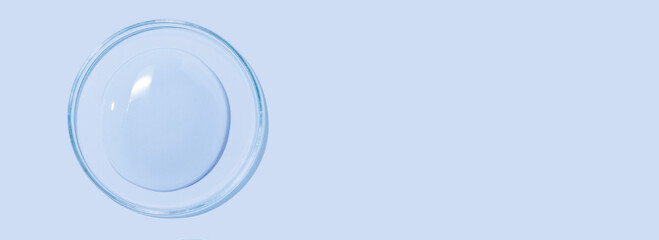 large drops of cosmetic serum, liquid, water, gel on a pink background